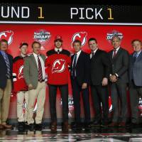Nico Hischier (center) poses with a large group after being selected as the No. 1 pick in the NHL Draft by the New Jersey Devils on Friday. Devils make Hischier No. 1 pick
