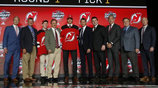 Nico Hischier (center) poses with a large group after being selected as the No. 1 pick in the NHL Draft by the New Jersey Devils on Friday. Devils make Hischier No. 1 pick