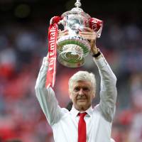Arsenal’s Arsene Wenger, seen holding the F.A. Cup trophy last week, signed a new contract to stay in charge for two more seasons. Arsenal putting off the inevitable by retaining Wenger