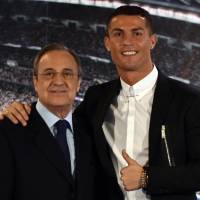 Real Madrid president and Cristiano Ronaldo are seen in a November 2016 file photo. Ronaldo not leaving Real Madrid, team president says