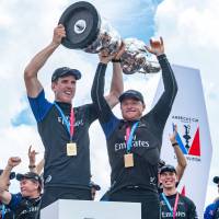 Emirates Team New Zealand helmsman Peter Burling (left) and skipper Glenn Ashby hold the America’s Cup aloft after Monday’s clinching victory over Oracle Team USA in Hamilton, Bermuda. Team New Zealand completes rout to capture America's Cup
