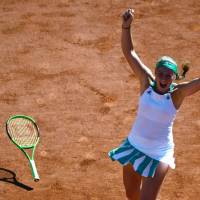 Latvia’s Jelena Ostapenko celebrates after beating Romania’s Simona Halep in the final of the French Open in Paris on Saturday. Ostapenko upsets Halep to win French Open title
