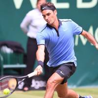 Roger Federer plays a shot from Florian Mayer in their quarterfinal match at the Gerry Weber Open on Friday. Federer won 6-3, 6-4. Federer cruises past Mayer, into Weber Open semifinals