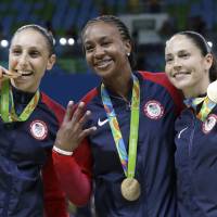 Diana Taurasi (left) is seen with U.S. Olympic teammates Tamika Catchings (center) and Sue Bird in a file photo taken at the 2016 Olympics in Rio de Janeiro. Taurasi becomes WNBA's all-time scoring leader