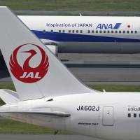 Japan Airlines and All Nippon Airways planes are seen at Haneda airport in Tokyo. ANA, JAL seek to stand out with diverse in-flight meals