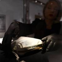 Sotheby’s Cassandra Hatton adjusts the Apollo 11 Contingency Lunar Sample Return Bag, used by Neil Armstrong on Apollo 11 to bring back the very first pieces of the moon ever collected, during a July 13 media preview for Space Exploration auction in New York. The bag, which was once nearly thrown out with the trash, sold at auction on Thursday for $1.8 million, Neil Armstrong's Apollo 11 moon sample bag fetches $1.8 million at auction