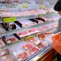 A customer shops for beef at a store in Tokyo. Japan expected to slap higher import tariff on frozen U.S. beef