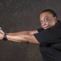 Lois Woods, an investigator with a career in law enforcement and a firearms instructor, poses for a portrait in Decatur, Georgia, holding her Glock firearm on July 10. U.S. black women are picking up firearms for self-defense in growing numbers