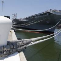 The aircraft carrier USS Gerald R. Ford is seen after its commissioning at Naval Station Norfolk in Norfolk, Virginia, on Saturday. Trump calls new aircraft carrier a '100,000-ton message to the world'