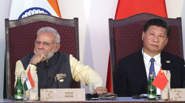 Indian Prime Minister Narendra Modi and Chinese President Xi Jinping listen to a speech during the BRICS summit in Goa, India, in October. India and China face off in border standoff as fears of all-out military conflict grow