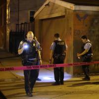 Chicago police investigate on Sunday after a man was shot in an alley in the Little Village neighborhood. More than 100 people shot in Chicago over Fourth of July weekend