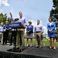 Virginia Sen. Mark Warner speaks about the Democratic Party’s economic plan at Rose Hill Park Monday in Berryville, Virginia, flanked by (from left) House Democratic leader Nancy Pelosi, Rhode Island Rep. David Cicilline, Massachusetts Sen. Elizabeth Warren, Maryland Sen. Chis Van Hollen, Minnisota Sen. Amy Klobuchar, New Mixico. Rep. Ben Ray Lujan, Illinois Rep. Cheri Bustos and Sen. Democratic leader Chuck Schumer. Democrats pitch 'A Better Deal' in populist bid to rebrand party