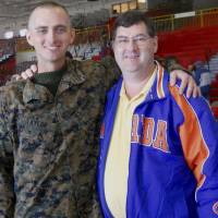 In this undated photo provided by David Taylor Sr., he poses with his son, David Taylor, a former Marine. Taylor Sr. told The Associated Press on Tuesday that he was notified by the U.S. State Department that his son was killed earlier this month in Syria while fighting for a Kurdish militia battling the Islamic State group. Ex-Marine killed in Syria was passionate about fight against Islamic State