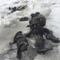 In this photo released by the Swiss train company Glacier 3000, shoes and clothing are visible at a Swiss glacier where two bodies were found. Police say the bodies of what appear to be two people killed in an accident decades ago have been recovered from the glacier in southwestern Switzerland. Valais canton police say the bodies were found on the Tsanfleuron glacier Friday. Swiss glacier yields bodies of pair who vanished in 1942