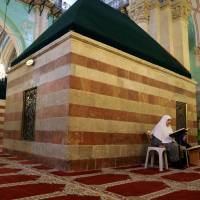 A Palestinian woman reads the Koran inside Ibrahimi Mosque, which Jews call the Jewish Tomb of the Patriarchs, in the West Bank city of Hebron on Friday. UNESCO puts Hebron on endangered heritage list, outraging Israel
