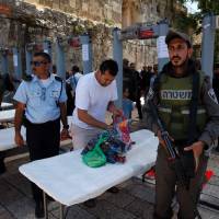 Israel reopens sensitive holy site in Jerusalem after attack, but Muslims refuse to enter