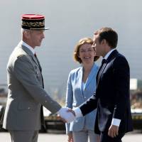 French President Emmanuel Macron greets newly named Chief of the Defense Staff French Army Gen. Francois Lecointre as French Defense Minister Florence Parly looks on during a visit at the military base in Istres, southern France, Thursday. Macron tries to mend fences after rebuke prompts military chief to resign