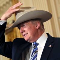U.S. President Donald Trump wears a cowboy hat as attends a “Made in America” products showcase event at the White House in Washington Monday. Trump camp agrees to share records about Mar-a-Lago visitors