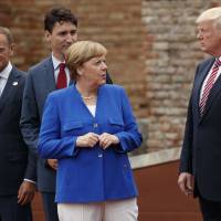German Chancellor Angela Merkel, accompanied (from left) by European Council President Donald Tusk and Canadian Prime Minister Justin Trudeau, talks with President Donald Trump during a family photo with G-7 leaders at the Ancient Greek Theater of Taormina in Taormina, Italy, in May. President Donald Trump will learn this week whether he gets a second chance to make a first impression as he returns to Europe and has his first encounter with Russia’s Vladimir Putin. Merkel camp's election program no longer refers to U.S. as 'friend' amid Trump chill