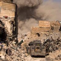 A picture taken on Monday shows smoke plumes billowing in the Old City of Mosul during the offensive by the Iraqi force to retake the embattled city from Islamic State (IS) group fighters. Islamic State holdouts fight on in west Mosul in battle Amnesty calls 'civilian catastrophe'