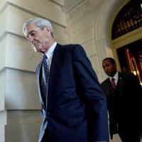 Former FBI Director Robert Mueller, the special counsel probing Russian interference in the 2016 election, departs Capitol Hill following a June 21 closed-door meeting in Washington. A 2001 Justice Department memo warned that no nation, including the United States, was immune from the threat posed by Russian organized crime. The special counsel investigation is bringing attention to Russian efforts to meddle in democratic processes, the type of intelligence gathering that in the past has relied on hired hackers. Mueller probe looks to focus on Russian organized crime operations, links to state