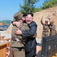 North Korean leader Kim Jong Un reacts with scientists and technicians of the country’s Academy of Defense Science after the test-launch of the Hwasong-14 intercontinental ballistic missile Tuesday. North Korea conducts public executions for theft, watching South Korea media: report