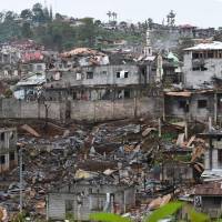 Destroyed buildings are seen from a government sniper’s position on the front-line of the battle against Islamic State-linked militants in the Philippine city of Marawi on Saturday. Islamic State galvanized in Asia by Philippine city siege, report says