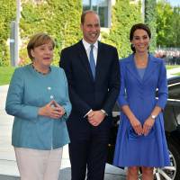 Britain’s Prince William and his wife, Catherine, Duchess of Cambridge, pose for a photograph with German Chancellor Angela Merkel in Berlin Wednesday. Prince William, Kate meet Merkel, tour Berlin Holocaust memorial