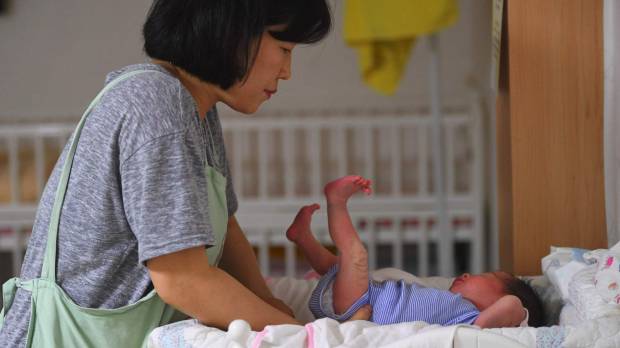 A social worker cares for a baby at the Jusarang Community Church in southern Seoul in May. South Korean child protection law sees more abandoned babies