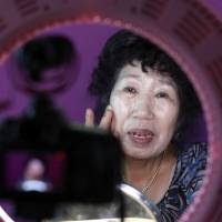 South Korean YouTube star Park Makrye, 70, gives a demonstration of makeup tutorials for her YouTube channel during an interview at her home in Yongin, South Korea, on Tuesday. Life begins at 70 for tremendouly popular South Korean YouTube star