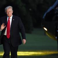U.S. President Donald Trump waves as he returns to the White House in Washington on Saturday. Home from the Group of 20 meeting, Trump tweeted that it’s time to begin working constructively with Russia, and that he’d discussed creating a cybersecurity unit with Russian President Vladimir Putin. Trump says U.S. must work with Russia, move past election issues