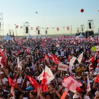 People cheer as Turkey’s main opposition Republican People’s Party (CHP) leader Kemal Kilicdaroglu throws flowers to supporters during a rally on Sunday in Istanbul marking the end of his 450-km “justice march” from Ankara to Istanbul. Ankara-Istanbul march culminates in huge rally against Turkey's post-coup crackdown