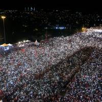 People gather for a ceremony marking the first anniversary of the attempted coup at the Bosphorus Bridge in Istanbul on Saturday. Turks marks a year since failed coup as Erdogan vows to 'rip heads off' terrorists and plotters