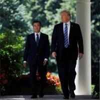 U.S. President Donald Trump arrives for a joint news conference with South Korean President Moon Jae-in at the Rose Garden of the White House in Washington on Friday. In meeting with Moon, Trump calls for firm response to North Korea but targets Seoul on trade