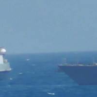An Iranian vessel steers close to the U.S. Navy coastal patrol craft USS Thunderbolt (right) in the Gulf in a still image from video provided by the U.S. Navy Tuesday. U.S. Navy patrol boat fires warning shots near Iran ship in Persian Gulf
