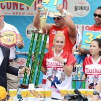 Miki Sudo receives a trophy after winning the women’s title in an annual hot dog eating contest in Coney Island, New York, on Tuesday. Miki Sudo downs 41 hot dogs in 10 minutes to win New York contest for fourth time