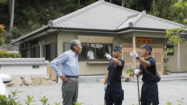 Police carry out an investigation in the grounds of a shrine in Kobe on Monday morning where Kanami Takeshima, a 26-year-old unemployed man, was arrested the previous day on suspicion of killing two of his grandparents and another elderly woman. Kobe man is handed fresh arrest warrant for allegedly murdering his grandfather