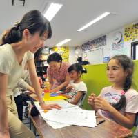 Children from foreign countries study Japanese and other subjects after school at YSC Global School in Fussa in western Tokyo on Wednesday. New kid on the block gets the least help in Japan's schools