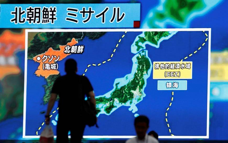 Passers-by in Tokyo on Tuesday look at a large monitor showing news of North Korea's intercontinental ballistic missile test. North Korean claim of successful ICBM test likely to raise alarm in Tokyo — and Anchorage