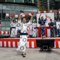 Dancers in kimono bearing the Tokyo 2020 Olympics emblem perform the “Tokyo Gorin Ondo” dance Monday at Toranomon Hills in Minato Ward to mark exactly three years until the start of the games. Three-year countdown to Tokyo 2020 Olympics begins with new song-and-dance routine