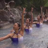 Mikako Kotani (front) and other former Olympians perform synchronized swimming in an Oita Prefecture hot spring. Oita aims to heat things up with video of Olympian synchronized swimming in <em>onsen</em>