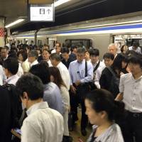 A train platform at JR Tokyo Station is jammed with commuters on June 28. Tokyo plans new effort to ease commuter hell on rush-hour trains