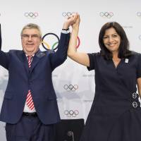 Mayor of Los Angeles Eric Garcetti (left), International Olympic Committee President Thomas Bach, and Mayor of Paris Anne Hidalgo during a press conference after the IOC Extraordinary Session, at the SwissTech Convention Centre, in Lausanne, Switzerland on July 11. Reducing the cost of hosting the Olympic Games