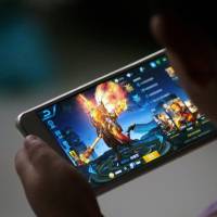 A child plays “Honour of Kings” by Tencent at home in Dezhou, Shandong province, on July 2. Last week the video game, which is played by roughly one in seven Chinese, was singled out by the People’s Daily for an unusually high-profile criticism. China's anti-addiction drive may ruin video games