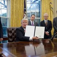 U.S. President Donald Trump holds up the executive order withdrawing the United States from the Trans-Pacific Partnership on Jan. 23 in the Oval Office of the White House. The rebirth of the Trans-Pacific Partnership
