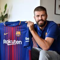 FC Barcelona defender Gerard Pique displays the team’s new shirt with the Rakuten logo during an exclusive interview with The Japan Times on Thursday. Rakuten, Barcelona hail official start of partnership, lucrative sponsorship