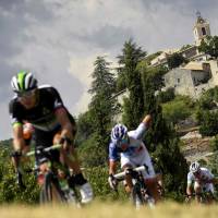 Norway’s Edvald Boasson Hagen (left) rides in a breakaway near a village during the 19th stage of theTour de France from Embrun to Salon-de-Provence on Friday. Hagen won the stage. Froome remains in control heading into last two stages