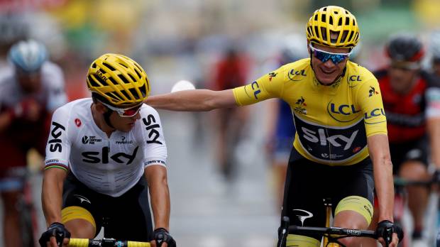 Chris Froome (right) shares a moment with a teammate during the final stage of the Tour de France on Sunday in Paris. Froome claims fourth Tour title