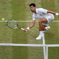 Novak Djokovic plays a shot against Adrian Mannarino in the fourth round at Wimbledon on Tuesday. REUTERS Three-time champ Djokovic outplays Mannarino to reach Wiimbledon quarterfinals