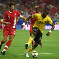 Jamaica’s Romario Williams controls the ball as Canada’s Dejan Jakovic defends during a CONCACAF Gold Cup quarterfinal match in Glendale, Arizona, on Thursday. Jamaica won 2-1. Jamaica, Mexico advance to Gold Cup semifinals